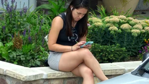 Thick brunette listening to music in shorts