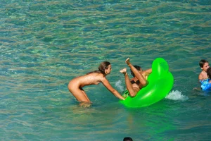 FKK Nudists playing in the water with floater