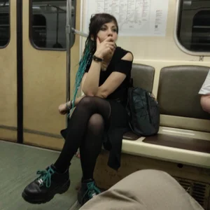 A Gothic Style Girl in a Dress, Black Pantyhose And Massive Boots Sitting With Crossed Legs in a Subway Train Creepshots