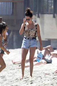 Ashley Tisdale in cheetah print swimsuit on the beach in Malibu