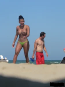 Hot ass topless beach girl with great tits lets her little brother oil up her ass in thong bikini