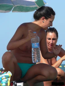 Bunch of sexy babes on the beach topless and in thong bikinis
