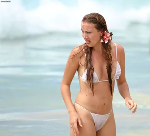 Sexy beach babe in see through wet white thong bikini