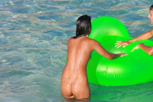 FKK Nudists playing in the water with floater