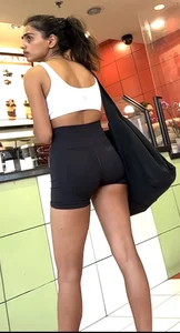 hot petite Indian chick showing some T&A in skimpy workout clothes