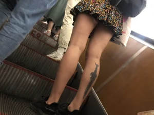 Candid Girl in a Skirt With a Tattoo on Her Calf Subway Escalator Creepshots Gallery