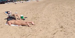 Girl laying out getting sun in a white thong bikini
