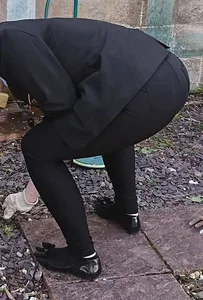 Teen in tight black pants bending over