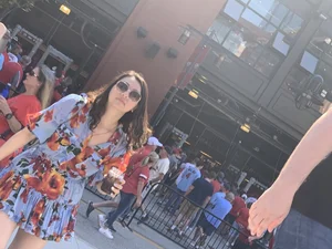 Bunch of girls in various outfits at a Cardinals baseball game