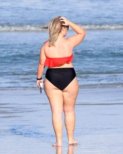 Thick BBW blonde lady in a bikini at the beach