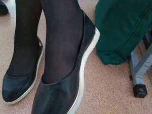 Closeups of college girls' legs and feet in pantyhose and various shoes (including high heels) in classrooms