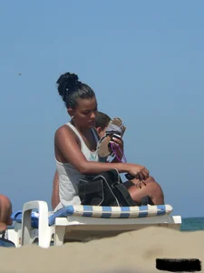 Hot ass topless beach girl with great tits lets her little brother oil up her ass in thong bikini