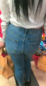 Skinny brunette with a nice booty in line in tight jeans