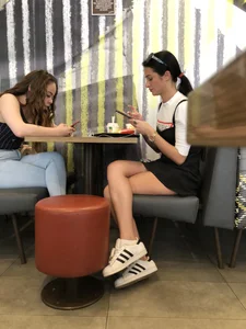 Two candid girls sitting in a restaurant