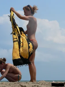 Two topless friends on the beach with nice boobs