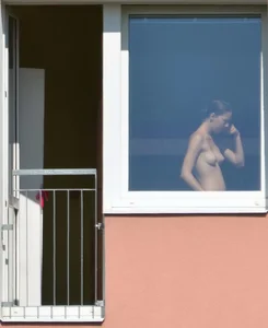 Peeping Tom pics of a topless girl in her house with nice tits