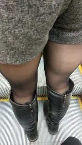 Legs in Shorts and Boots Escalator Closeup
