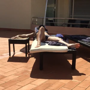 Blonde laying out in a blue bikini with a sexy body