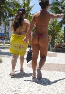 Big booty babe walking by the beach in thong