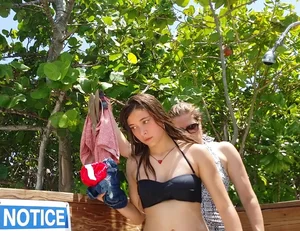 Beautiful brunette teen in black bikini leaving a Grand Turk beach