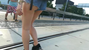 Girl walking in denim shorts showing some of her ass cheeks