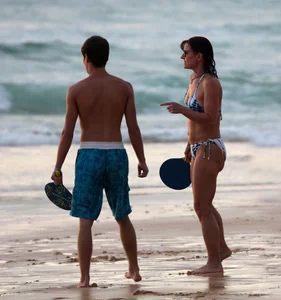 Older lady playing on the beach in her bikini