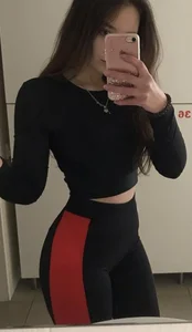 Hot Skinny Girl in a Top And Yoga Pants Mirror Selfie