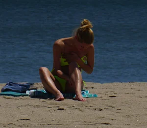 Sexy ass blonde milf on the beach in a thong with cameltoe and bending over