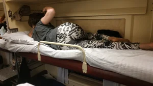Beautiful Photos of a Girl in Leggings And Pantyhose Lying on Top Shelf of the Train Sleeping Car