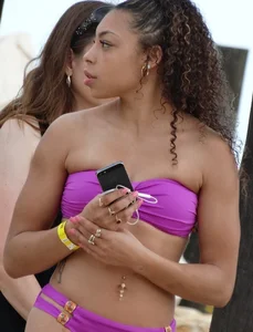Sexy light skinned black girl in a purple bikini busted