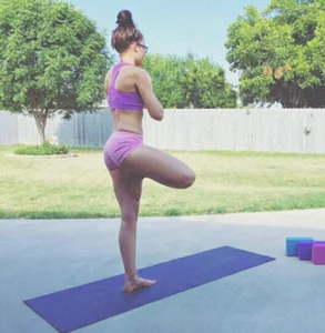 Girl in a Top and Mini Shorts Doing Yoga