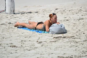 Redhead with nice tits in a bikini on the beach