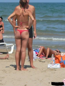 A bunch of hot babes on the beach in thong bikinis