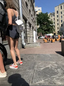 Bike girl's hot slim legs and booty in shorts