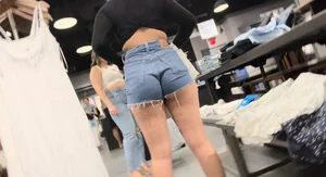 Hot candud butt in fringed denim shorts at the clothing store creepshot