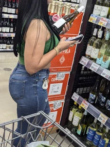 Sexy Latina buying wine