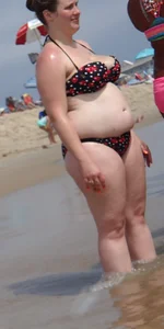 Fat chick with big boobs at the beach in a bikini