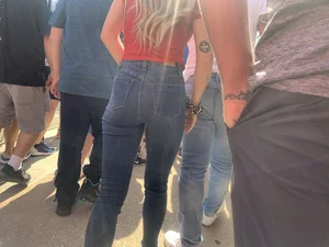 Bunch of girls in various outfits at a Cardinals baseball game