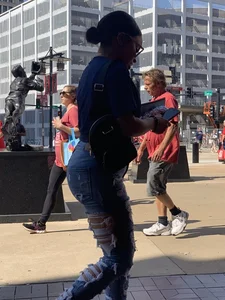 Bunch of girls in various outfits at a Cardinals baseball game
