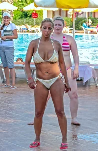Big boobed blonde milf dancing by the pool in a bikini