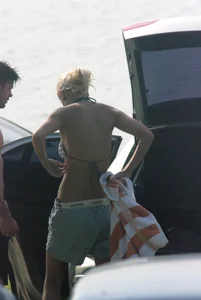 Blonde babe changing into and out of bikini and shows her tits