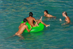 FKK Nudists playing in the water with floater