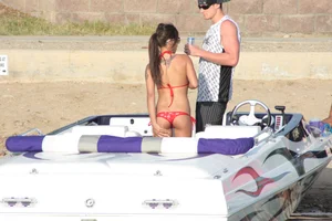 Brunette on a boat in red thong bikini with a tight little ass