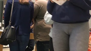 Blonde teen shopping at an Apple store in tight grey leggings