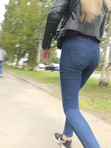 Young Blonde Girl in Tight Blue Jeans Scratching Her Booty While Passing By on the Suburban Street Creepshots Gallery