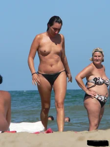 Bunch of sexy babes on the beach topless and in thong bikinis