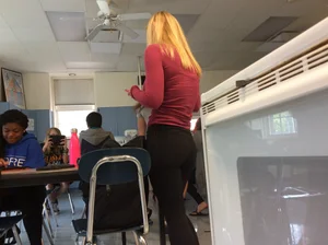 College blonde candid teen in leggings bending over in classroom