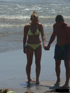 Sexy blonde on the beach in a yellow thong bikini