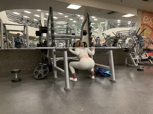 Hot gym babe in grey leggings with a nice ass doing squats