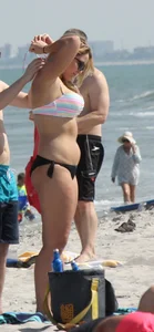 Big boobed thick blonde on the beach in a bikini